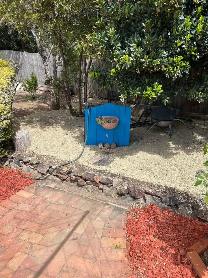 Cleared gravel garden corner after